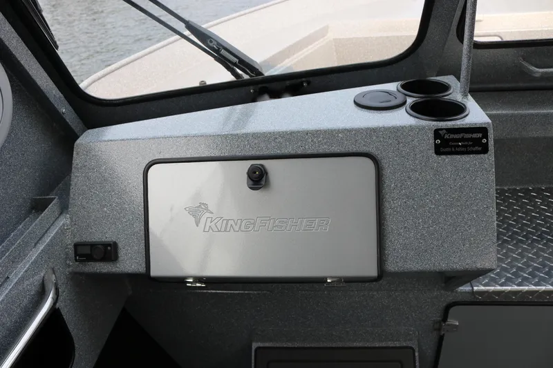 Slide: The Image of Interior view of 2026 KingFisher 2425 Escape HT boat, featuring storage compartment and cup holders. - 9