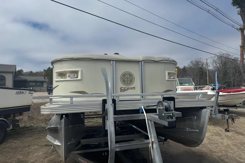 The Image of 2003 Crest II LM pontoon boat on trailer, side view. - 1