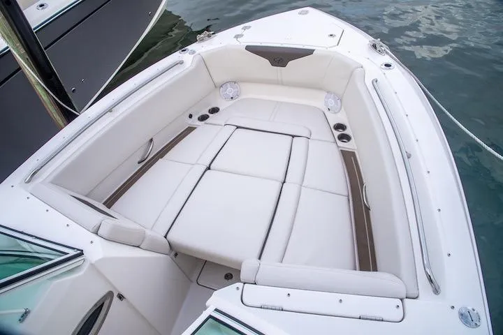 Slide: The Image of Luxurious seating area on 2027 Sailfish 276 DC boat, featuring white upholstery and cup holders. - 10