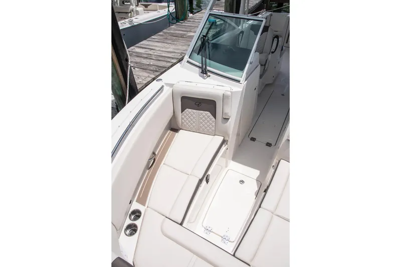 Slide: The Image of 2027 Sailfish 276 DC boat interior with cushioned seating and storage compartments. - 12