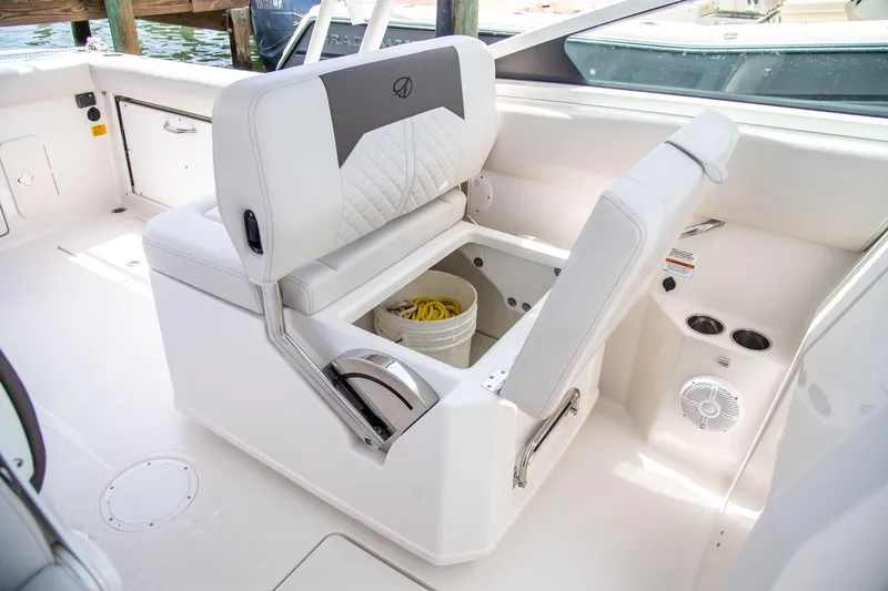 Slide: The Image of 2027 Sailfish 276 DC boat interior with storage compartment and seating. - 19
