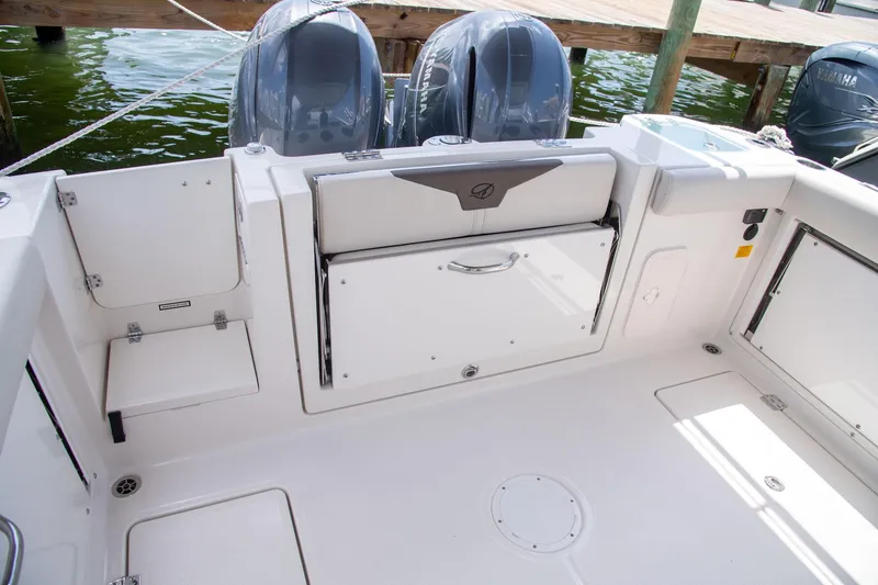 Slide: The Image of 2027 Sailfish 276 DC boat deck with storage compartments and dual engines. - 25