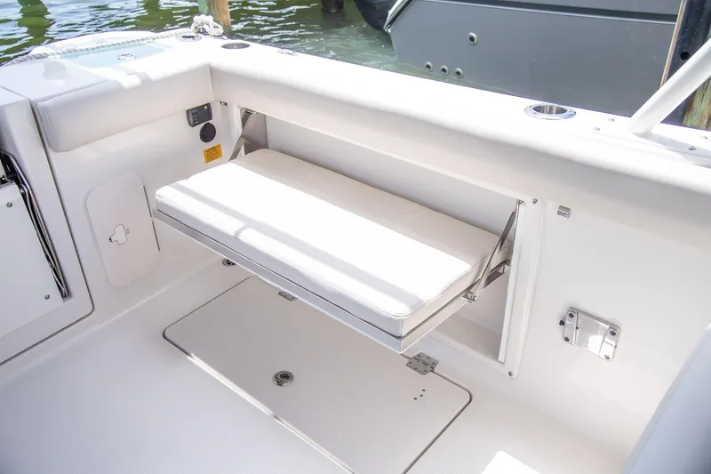Slide: The Image of 2027 Sailfish 276 DC boat interior with foldable seat and storage compartment. - 26