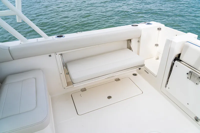 Slide: The Image of 2027 Sailfish 276 DC boat interior with white seating and storage compartments. - 29