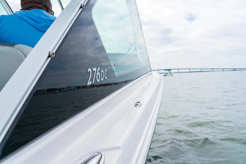 Slide: The Image of 2027 Sailfish 276 DC boat on water, showcasing sleek design and modern features. - 3
