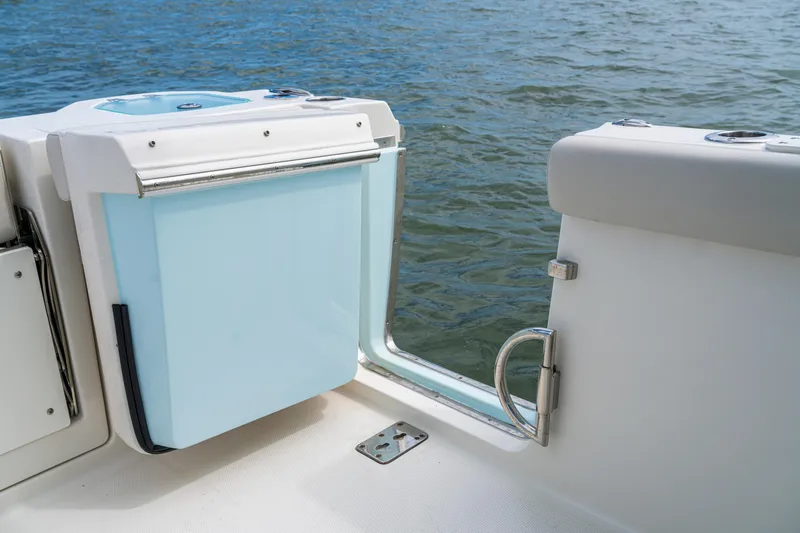 Slide: The Image of Sailfish 276 DC 2027 boat interior with open door, overlooking water. - 30