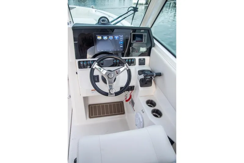 Slide: The Image of Helm of 2027 Sailfish 276 DC boat with modern controls and navigation display. - 6