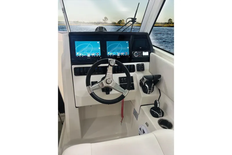 Slide: The Image of Helm of 2027 Sailfish 276 DC boat with dual screens and steering wheel. - 7