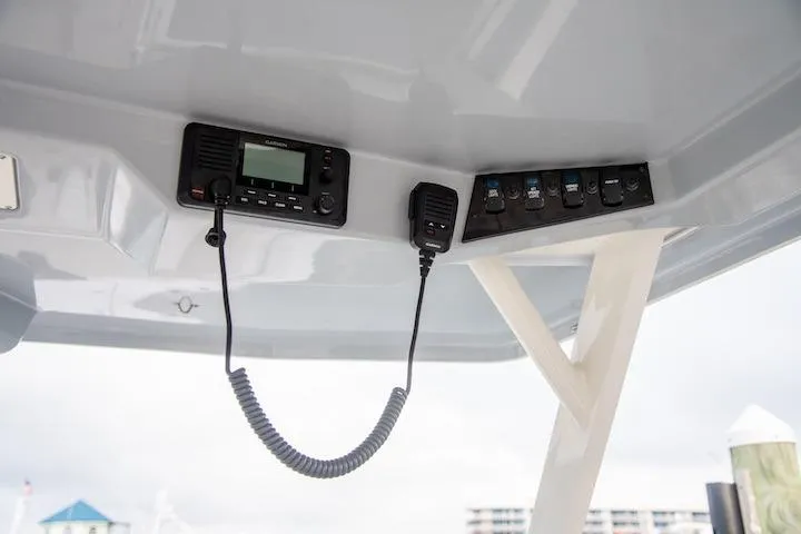 Slide: The Image of Control panel of 2027 Sailfish 276 DC boat with radio and switches. - 9