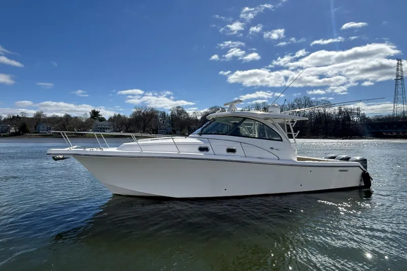 The Image of 2018 Pursuit OS 385 Offshore boat on calm water under a clear blue sky. - 0
