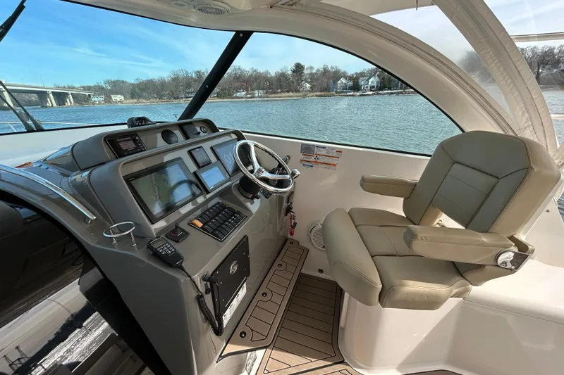 Slide: The Image of 2018 Pursuit OS 385 Offshore helm with modern navigation equipment and comfortable seating. - 10