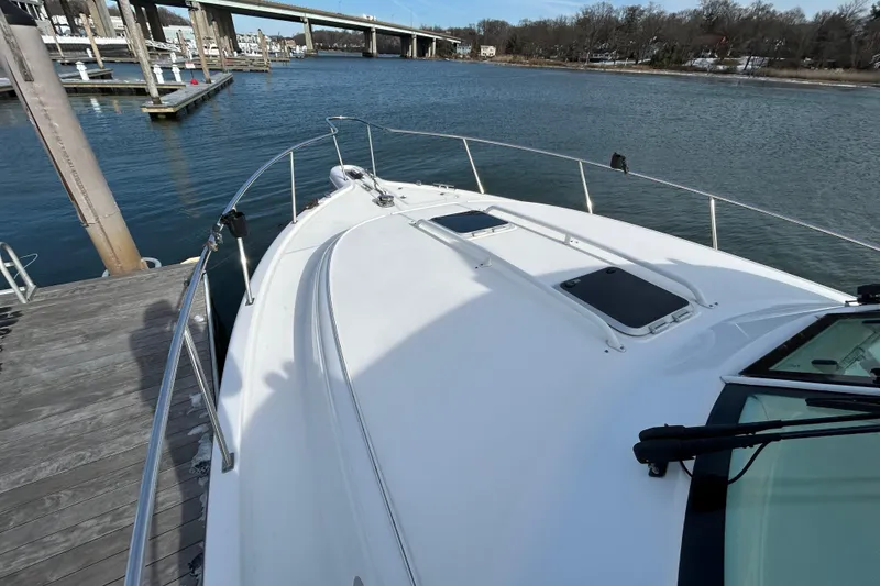 Slide: The Image of 2018 Pursuit OS 385 Offshore boat docked by a serene waterfront. - 12