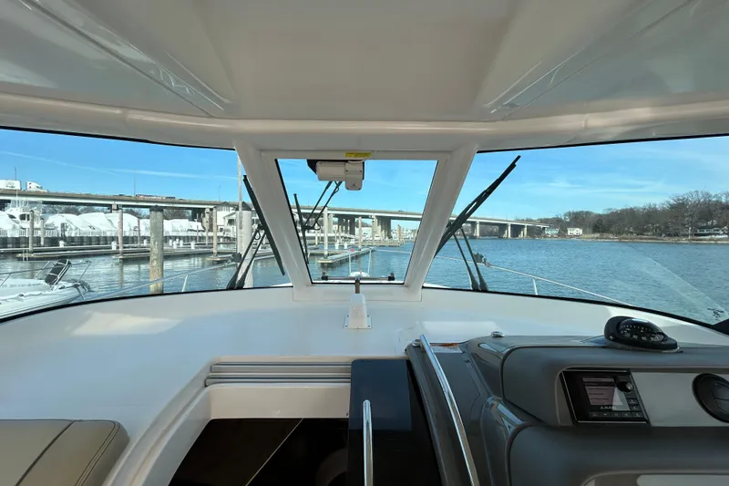 Slide: The Image of 2018 Pursuit OS 385 Offshore boat interior with bridge view and navigation equipment. - 13