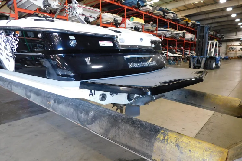 Slide: The Image of 2009 MasterCraft X55 boat in storage facility, rear view with swim platform. - 14