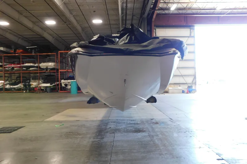 Slide: The Image of 2009 MasterCraft X55 boat stored indoors, covered, in a spacious warehouse. - 17