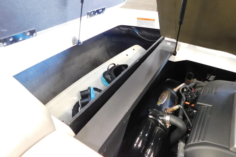 Slide: The Image of 2009 MasterCraft X55 engine compartment with storage area and visible components. - 20
