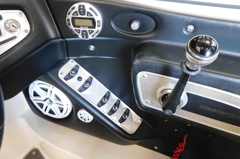 Slide: The Image of 2009 MasterCraft X55 boat dashboard with controls, Kenwood audio system, and speakers. - 24