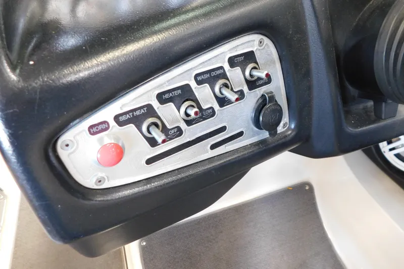 Slide: The Image of Control panel of a 2009 MasterCraft X55 boat with various switches and a horn button. - 25