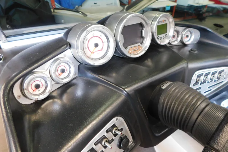 Slide: The Image of Dashboard of a 2009 MasterCraft X55 boat with gauges and controls. - 26