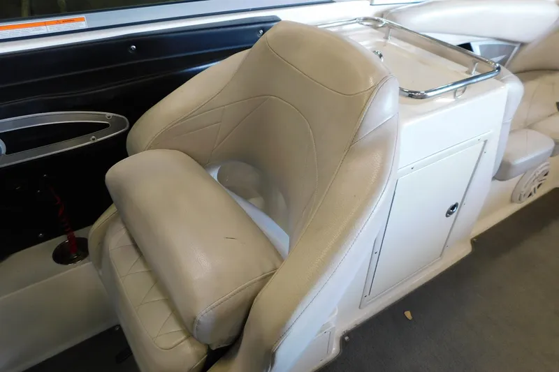 Slide: The Image of 2009 MasterCraft X55 boat interior with beige leather seating and storage compartment. - 27