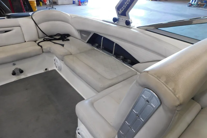 Slide: The Image of 2009 MasterCraft X55 boat interior with beige seating and cup holders. - 29