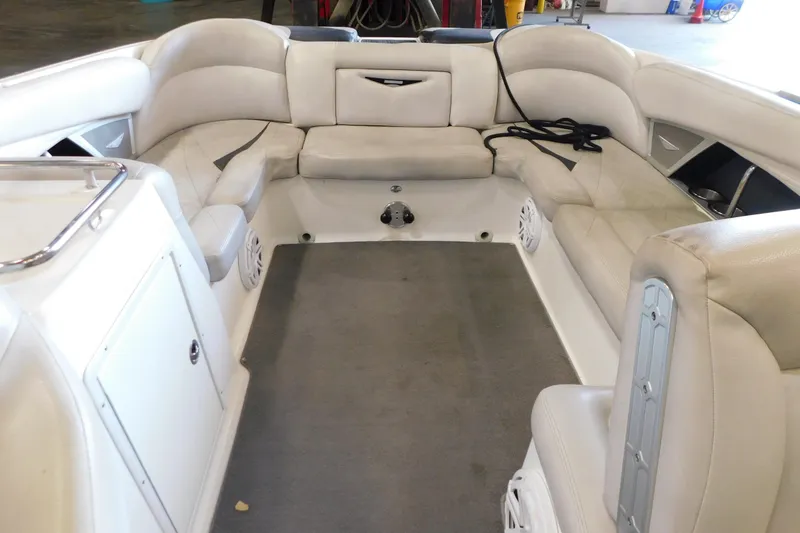 Slide: The Image of Interior of a 2009 MasterCraft X55 boat with white seating and carpeted floor. - 31
