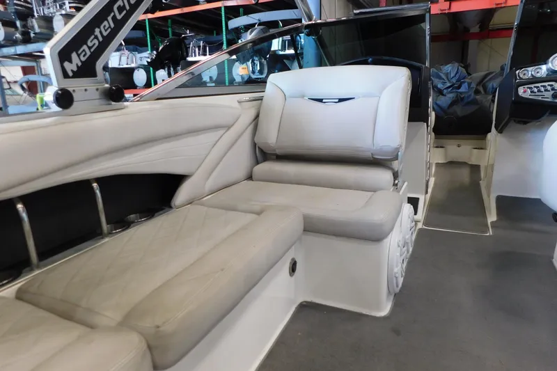 Slide: The Image of Interior of 2009 MasterCraft X55 boat with white seating and dashboard view. - 34