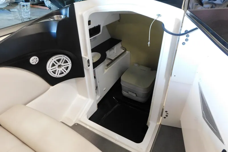Slide: The Image of 2009 MasterCraft X55 boat interior with compact restroom and speaker system. - 36