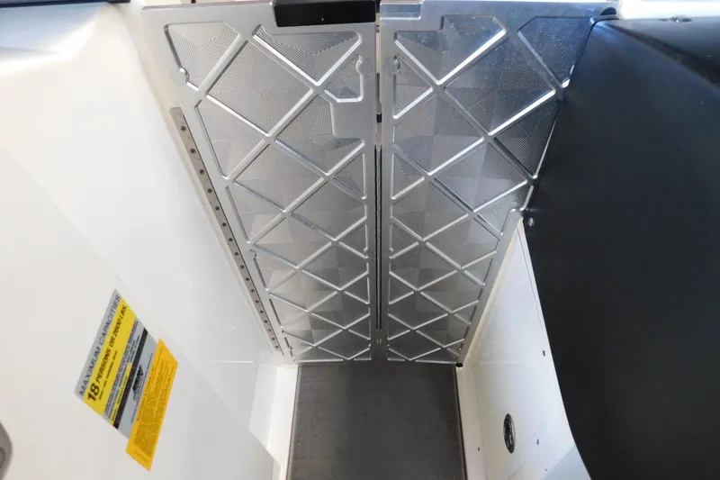 Slide: The Image of 2009 MasterCraft X55 boat interior with metal paneling and safety label. - 38