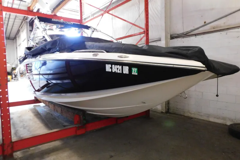 Slide: The Image of 2009 MasterCraft X55 boat stored indoors, covered and elevated on a rack. - 4