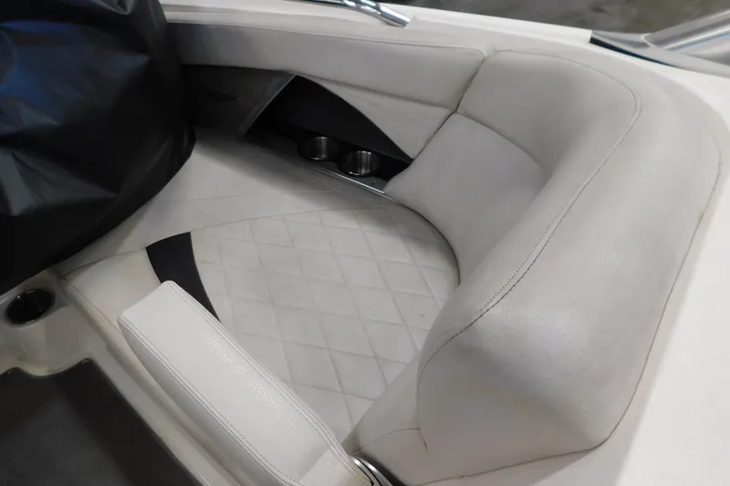 Slide: The Image of 2009 MasterCraft X55 boat interior with white cushioned seating and cup holders. - 40