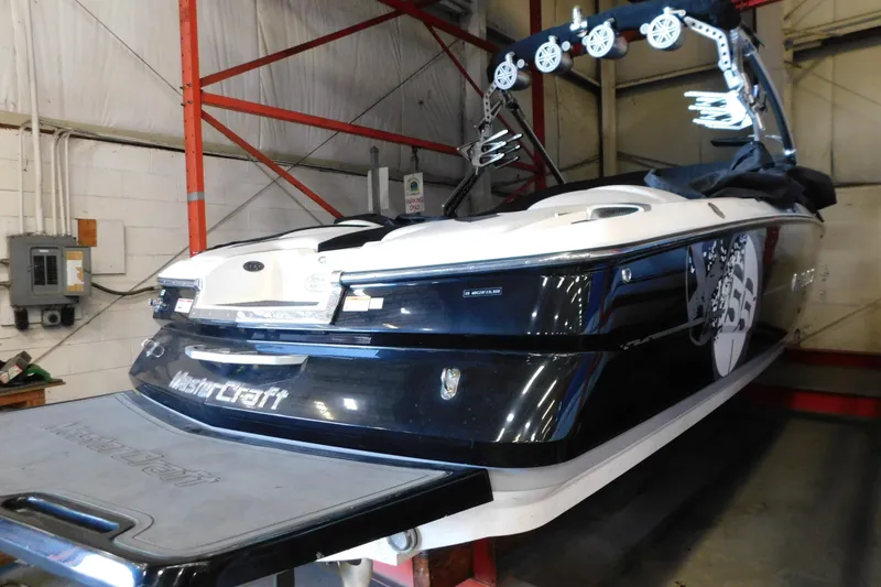 Slide: The Image of 2009 MasterCraft X55 boat in a warehouse, showcasing sleek design and modern features. - 5