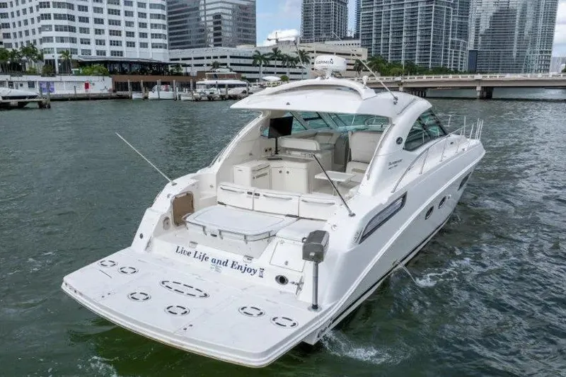 Slide: The Image of 2009 Sea Ray 43 Sundancer yacht cruising in urban waterfront setting. - 11