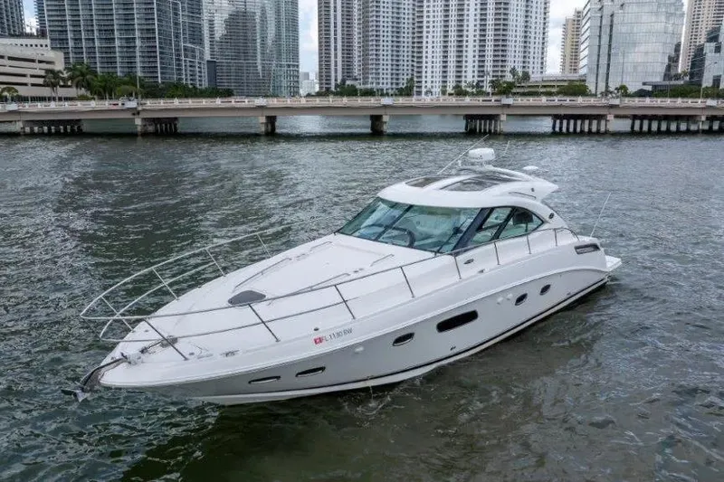 Slide: The Image of 2009 Sea Ray 43 Sundancer yacht cruising in urban waterfront setting. - 12
