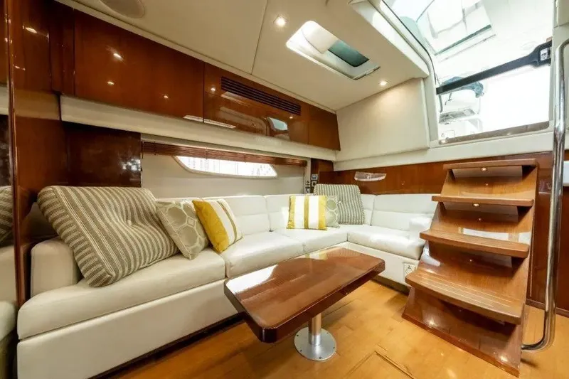 Slide: The Image of Luxurious interior of 2009 Sea Ray 43 Sundancer yacht with plush seating and wooden accents. - 16
