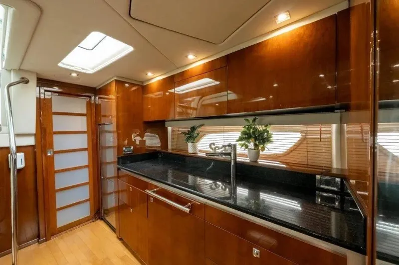 Slide: The Image of Luxurious 2009 Sea Ray 43 Sundancer yacht interior with sleek wooden cabinetry and modern fixtures. - 20