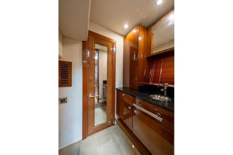 Slide: The Image of Luxurious interior of 2009 Sea Ray 43 Sundancer yacht with sleek wood cabinetry and modern fixtures. - 23