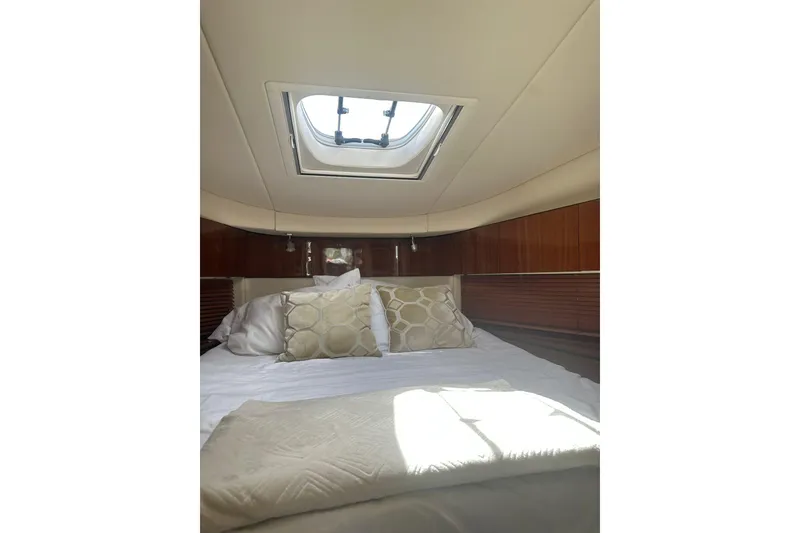 Slide: The Image of Luxurious cabin interior of 2009 Sea Ray 43 Sundancer yacht with skylight and plush bedding. - 30