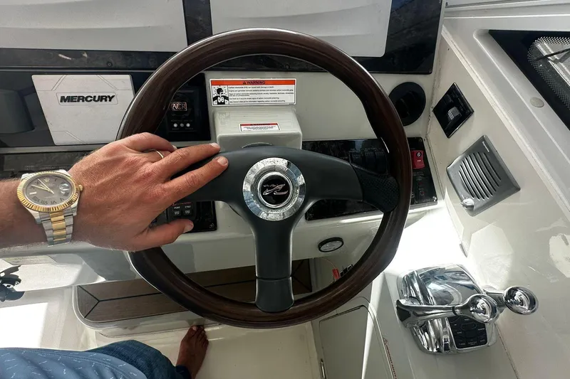 Slide: The Image of Steering wheel of a 2009 Sea Ray 43 Sundancer yacht with Mercury controls. - 32