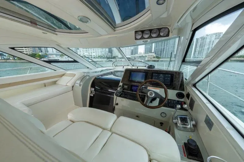 Slide: The Image of Luxurious interior of 2009 Sea Ray 43 Sundancer yacht with modern helm and panoramic windows. - 50