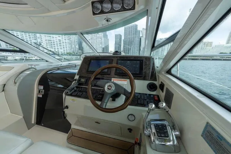 Slide: The Image of Interior helm of 2009 Sea Ray 43 Sundancer yacht with city skyline view. - 51