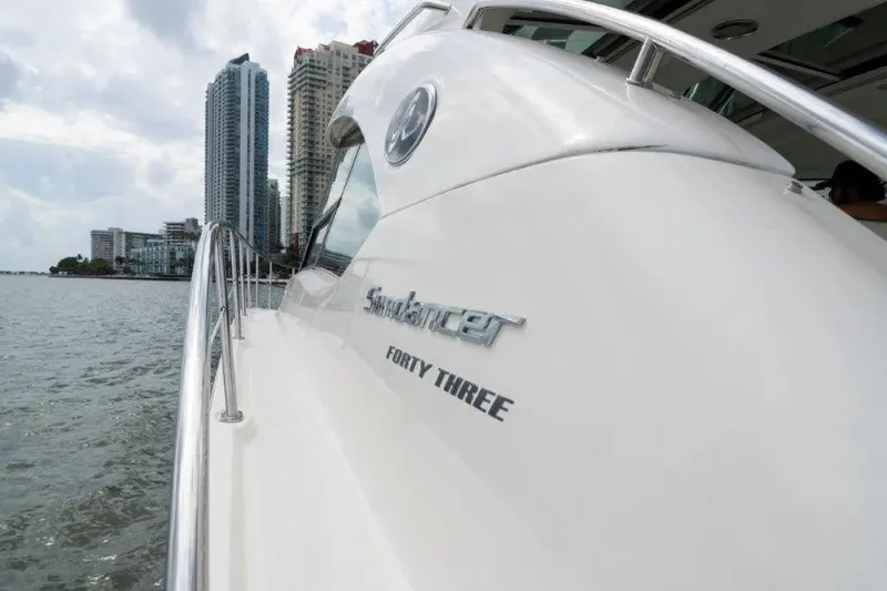 Slide: The Image of 2009 Sea Ray 43 Sundancer yacht cruising near city skyline. - 53