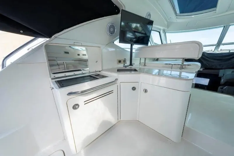Slide: The Image of Luxurious 2009 Sea Ray 43 Sundancer yacht interior with sleek kitchenette and modern amenities. - 56