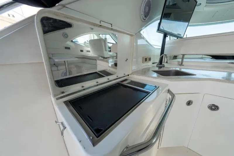 Slide: The Image of 2009 Sea Ray 43 Sundancer yacht interior with sleek kitchenette and modern amenities. - 57
