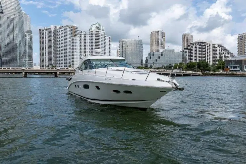 Slide: The Image of 2009 Sea Ray 43 Sundancer yacht cruising in urban waterfront setting. - 6