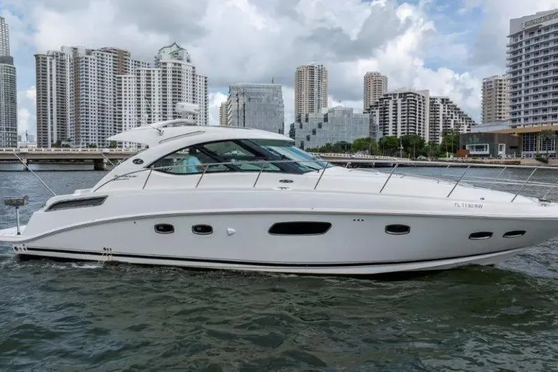 Slide: The Image of 2009 Sea Ray 43 Sundancer yacht cruising in urban waterfront setting. - 7