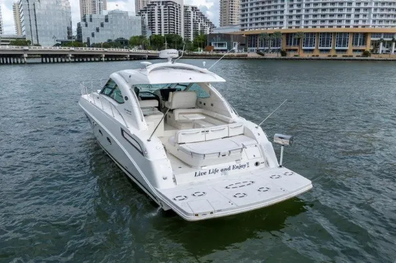 Slide: The Image of 2009 Sea Ray 43 Sundancer yacht cruising near urban waterfront. - 8