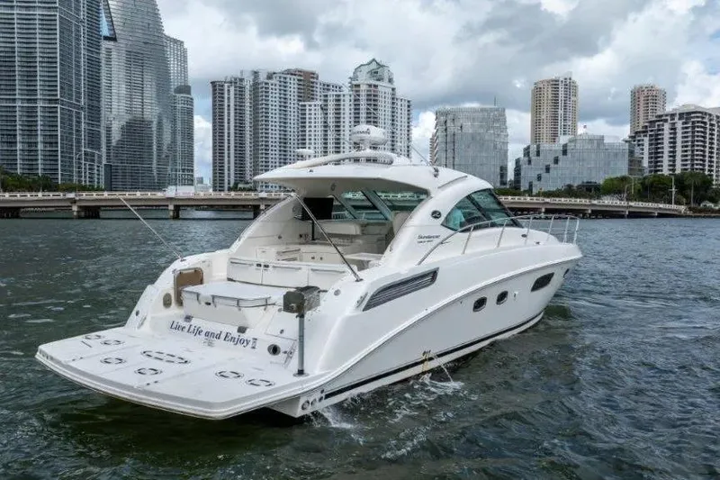 Slide: The Image of 2009 Sea Ray 43 Sundancer yacht cruising near city skyline. - 9