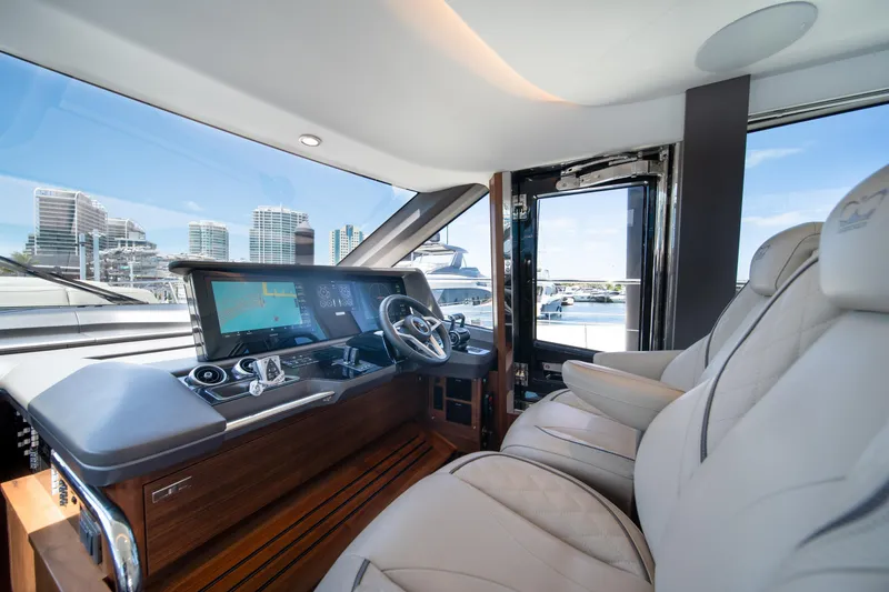 Slide: The Image of Luxurious 2025 Princess F65 yacht cockpit with modern navigation system and plush seating. - 19