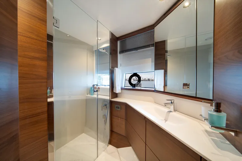 Slide: The Image of Luxurious bathroom interior on 2025 Princess F65 yacht, featuring sleek wood and glass design. - 26